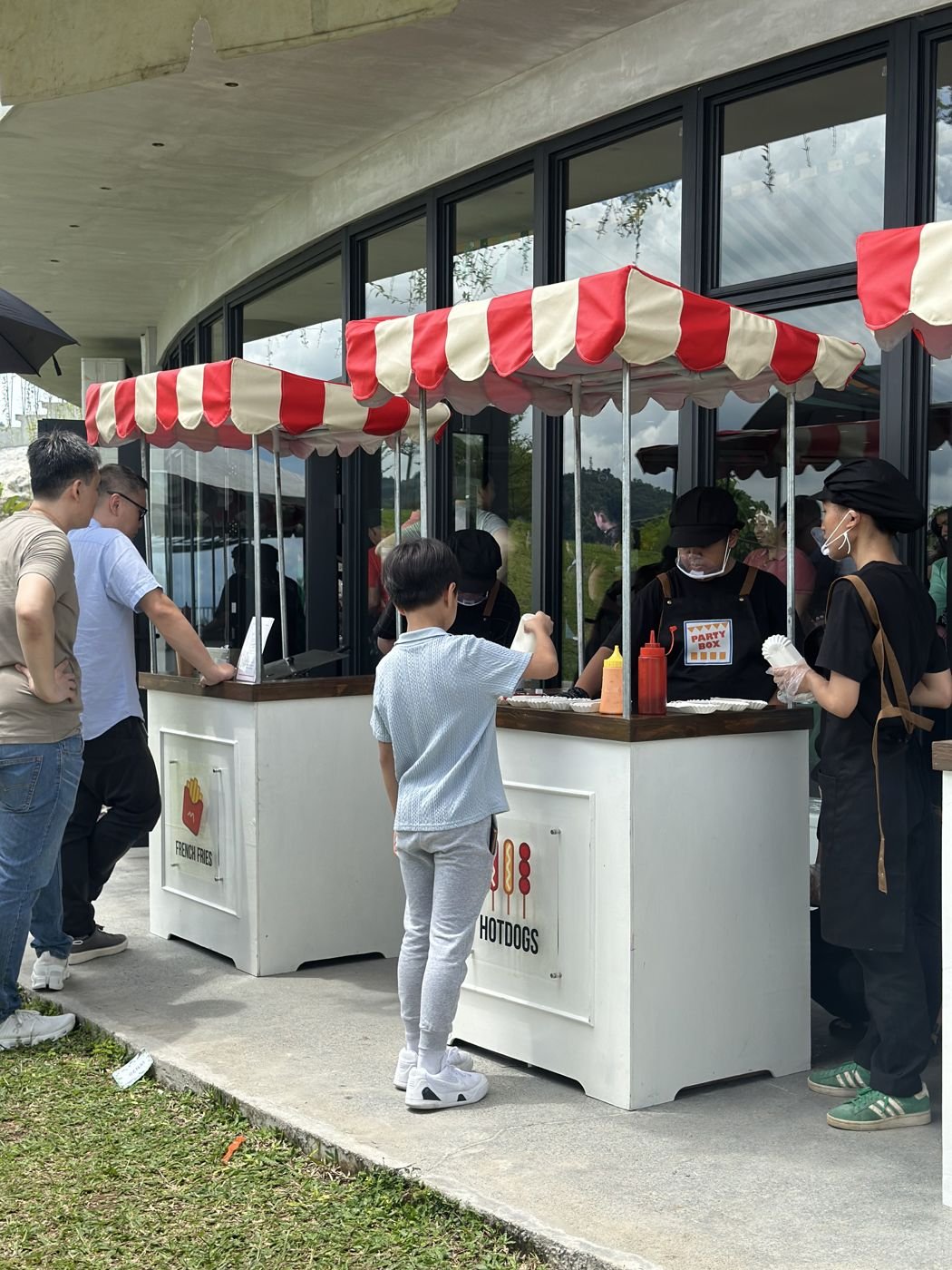 Guests lining up at the fries and hotdog carts