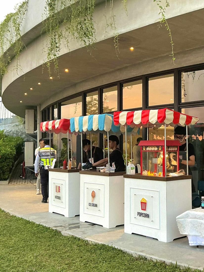 Hotdog, ice cream and popcorn carts at a venue at dusk