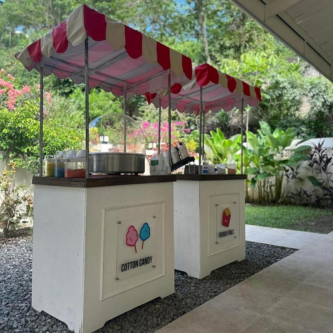 Cotton candy and fries carts in a tropical garden