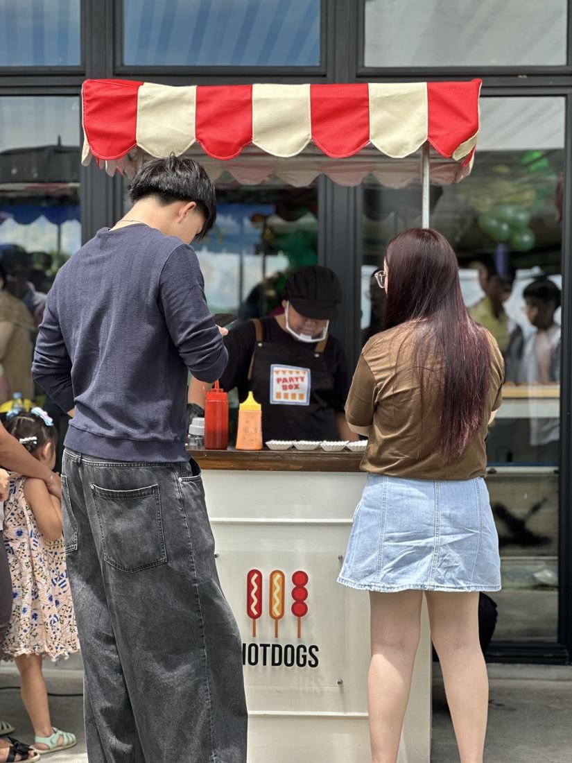 Guests ordering at the hotdog cart