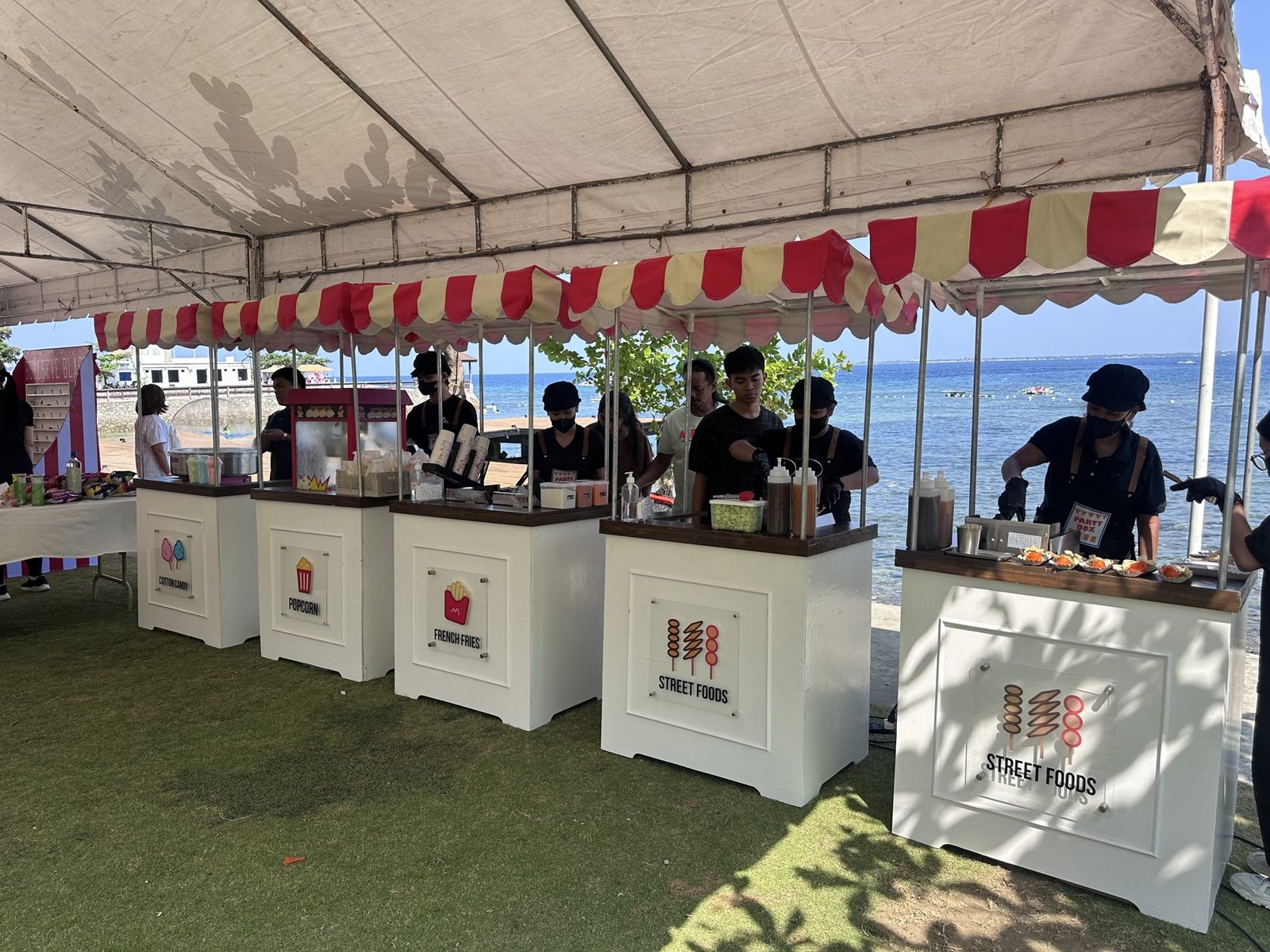 Seaside row of PartyBox carts with crew serving guests